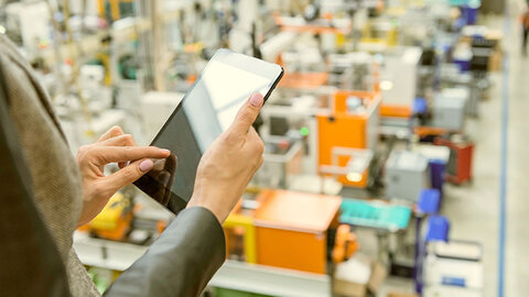 Tablet in der Hand in Lagerhalle