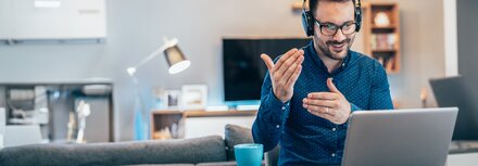 Security Awareness von EWE Mann mit Headset erklärt etwas vor dem Laptop
